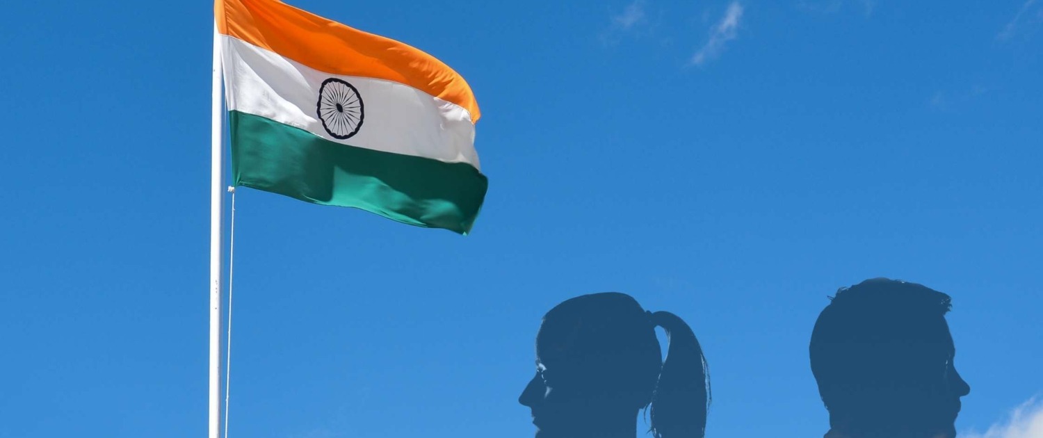 Image of India national flag with profiles of man and woman facing away from each other